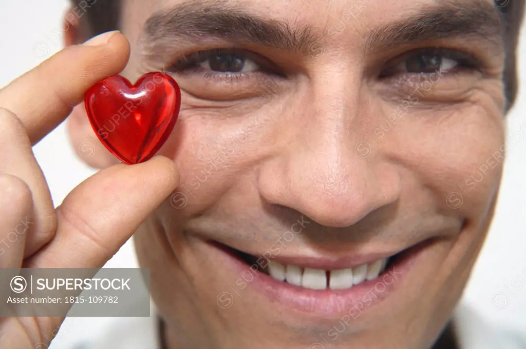 Man holding red heart, close_up
