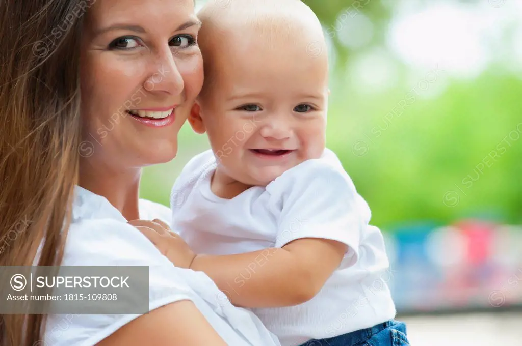 USA, Texas, Mother carrying son, smiling