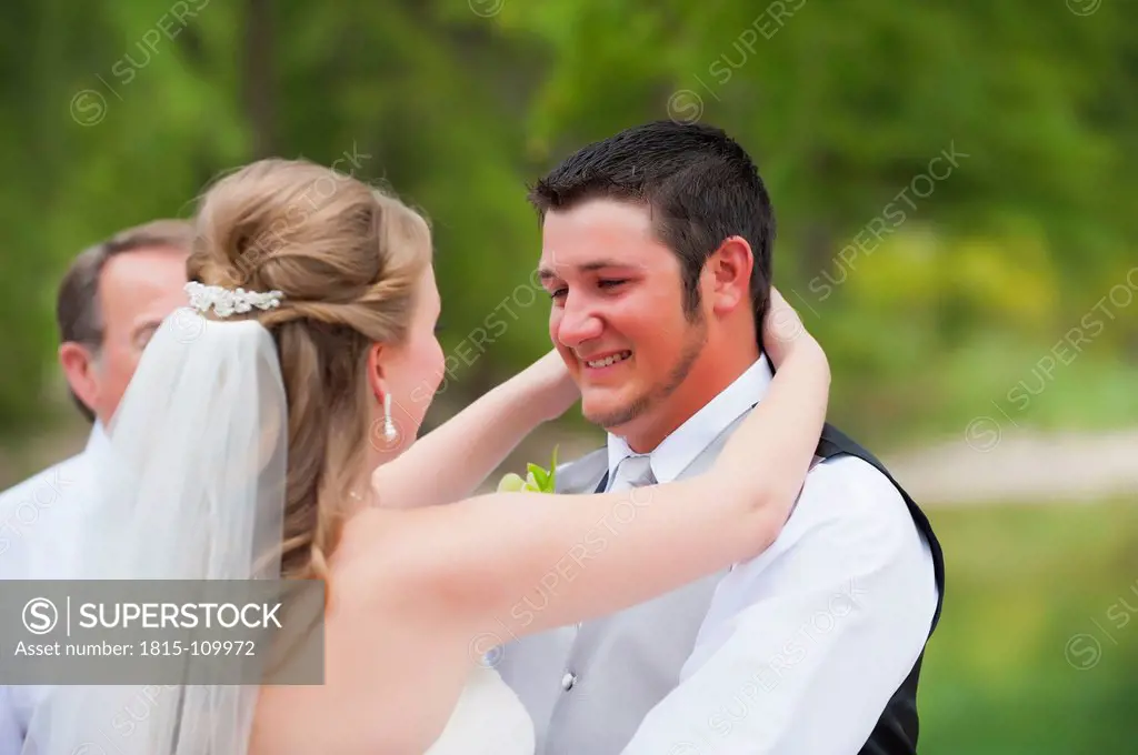 USA, Texas, Bride and groom embracing, smiling
