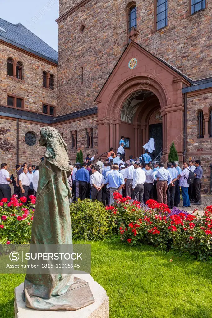 Germany, Hesse, Ruedesheim, St. Hildegard's Abbey, conventual church, visitors and statue of Hildegard of Bingen