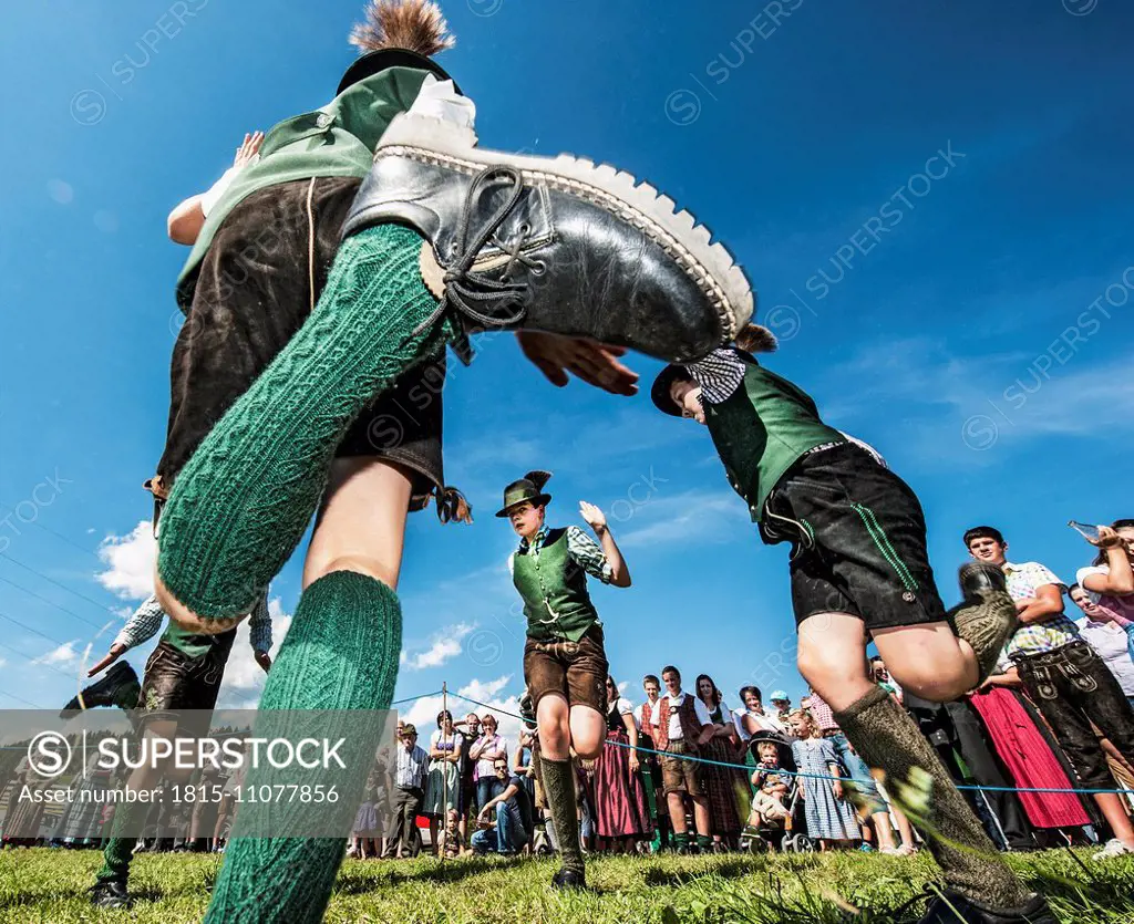 Austria, Irdning, Boys in traditional clothing dancing the Schuhplattler at May festival