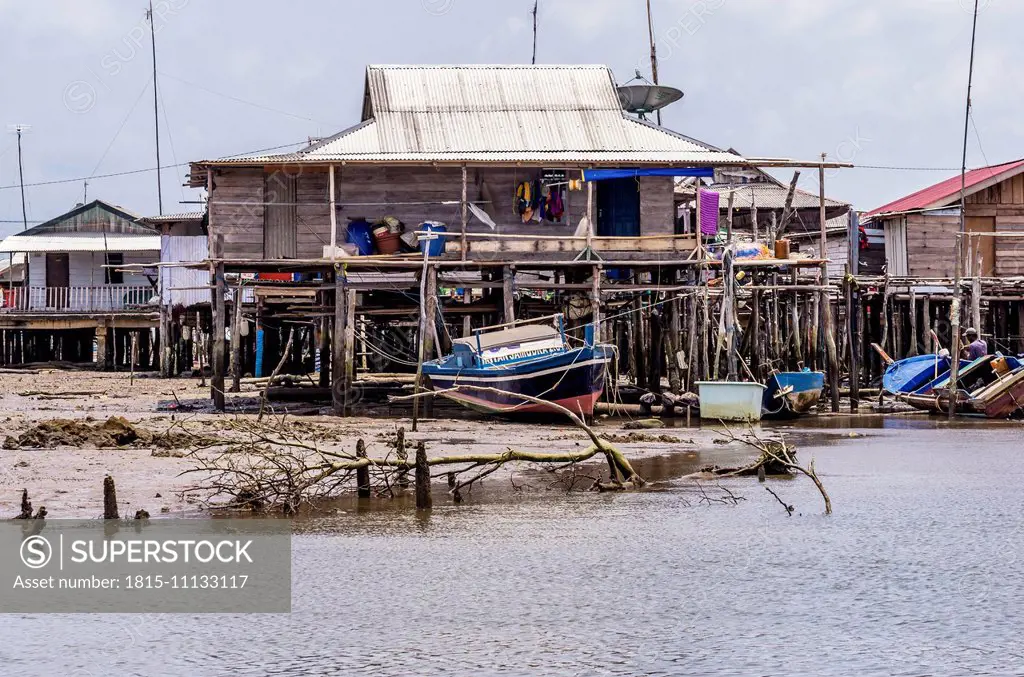 Indonesia, Riau Islands, Bintan Island, Fishing village, Fishing hut and fishing boat