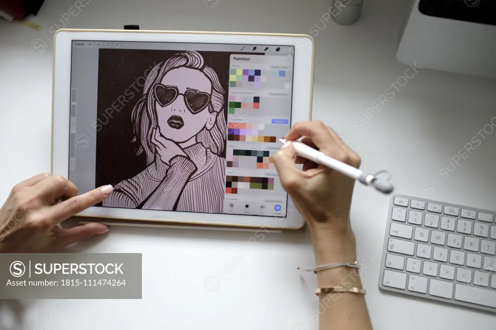 Female web designer using tablet at home