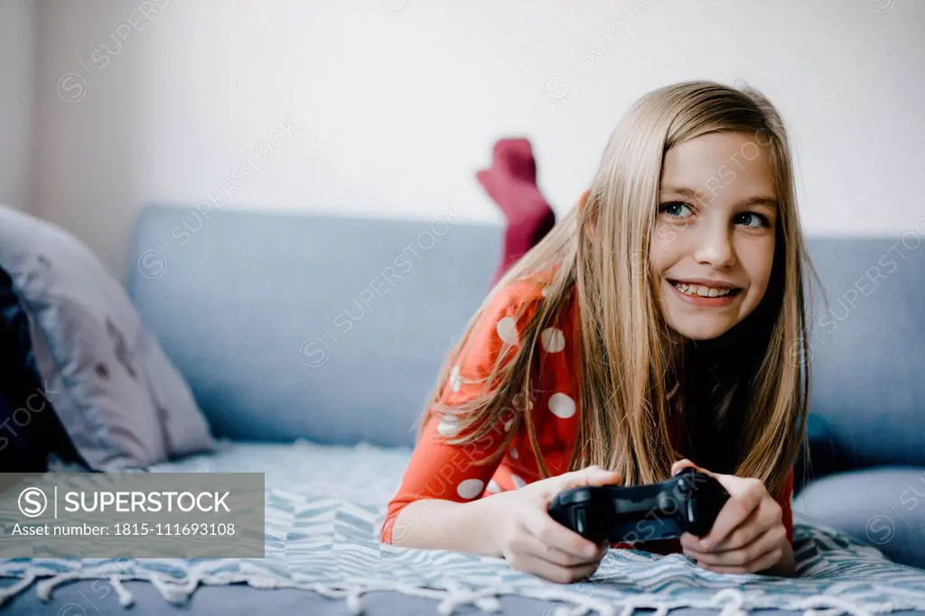 Happy girl playing video game at home