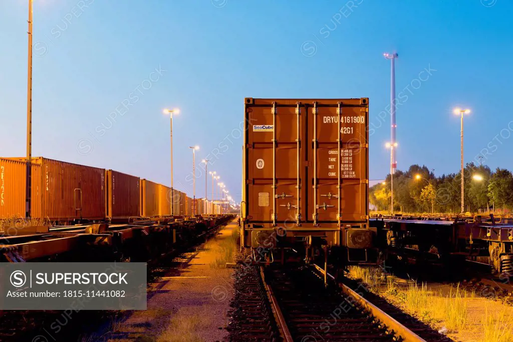 Germany, Hamburg, railway yard, freight train in the evening light