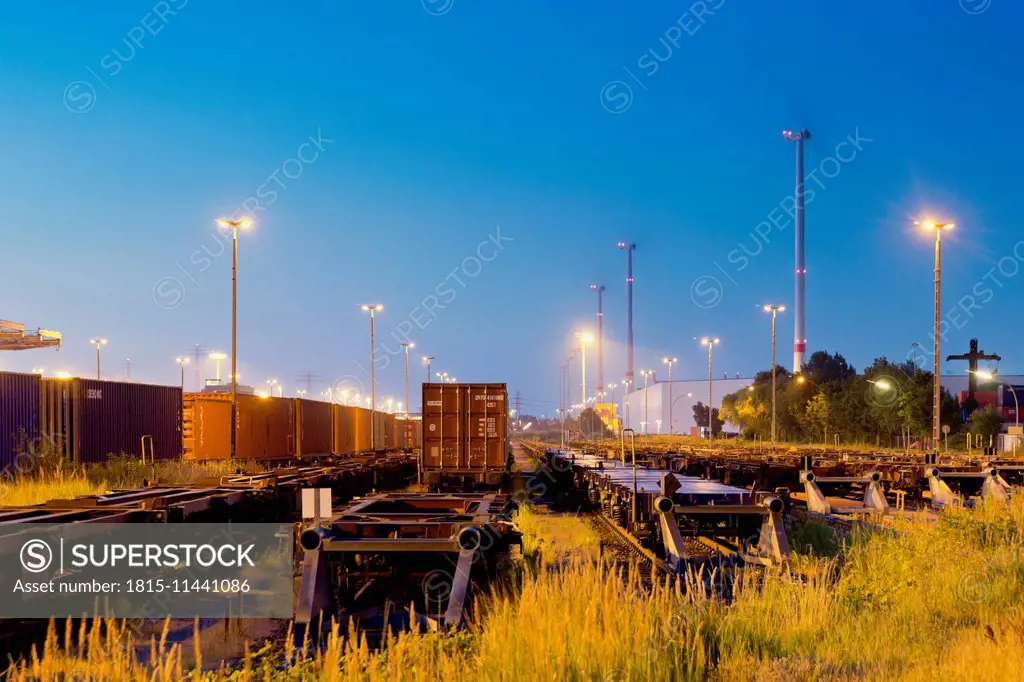 Germany, Hamburg, railway yard, freight train in the evening light
