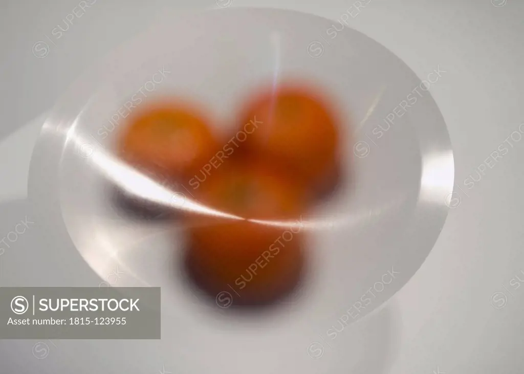 Bowl of mandarin oranges on grey background, close up