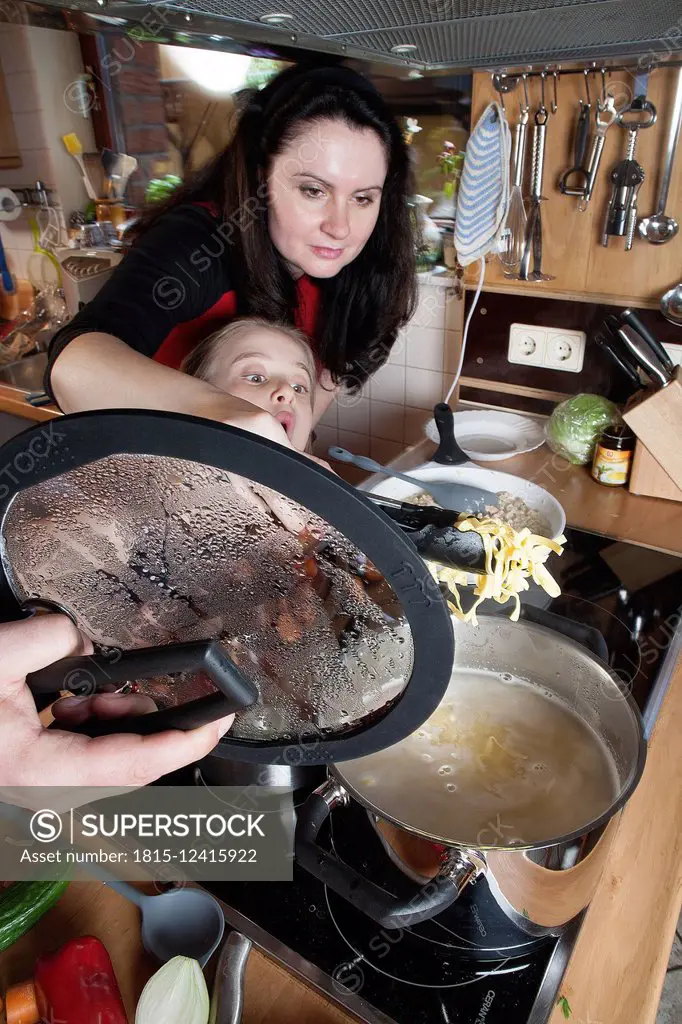 Parents and daughter cooking