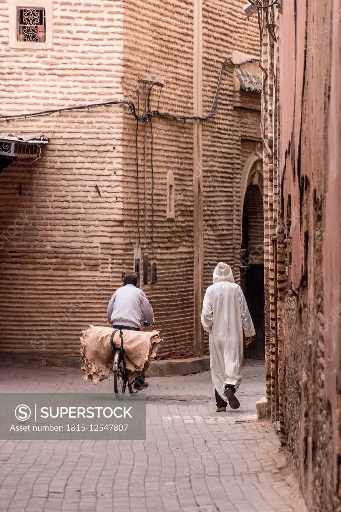 Morocco, Marrakesh, street scene with pedestrian and cyclist