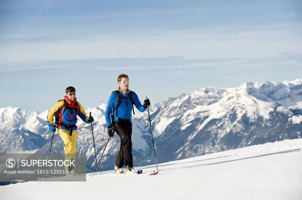 Austria, Men skiing on mountain at Alpbachtal