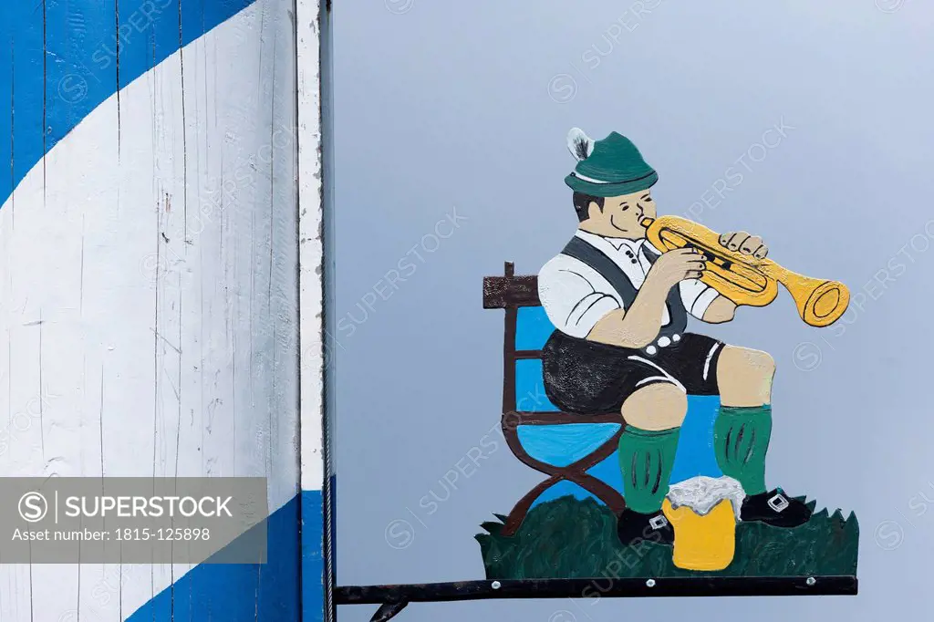 Germany, Bavarian trumpet player with beer mug painted on maypole