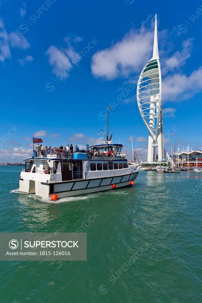 England, Hampshire, Portsmouth, View of excursion boat in harbour and Spinnaker Tower in background
