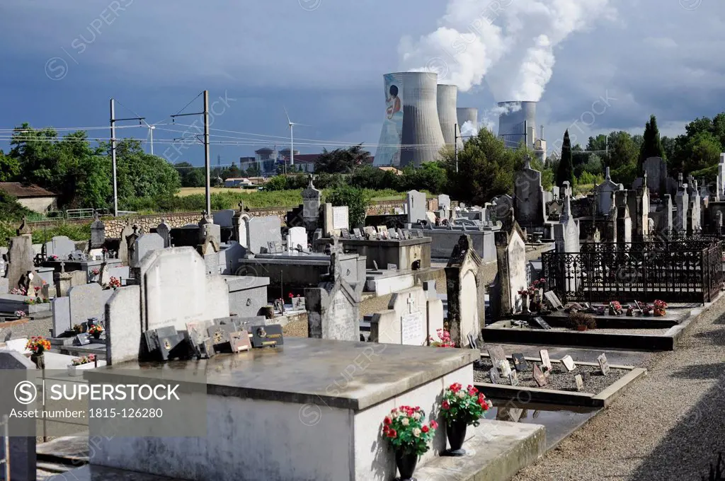 France, Rhone, Cemetery with smoking cooling towers of power plant in background