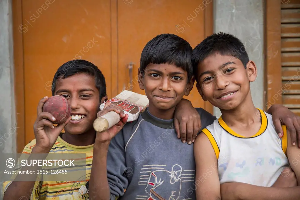 India, Amritsar, Portrait of boys playing cricket, smiling