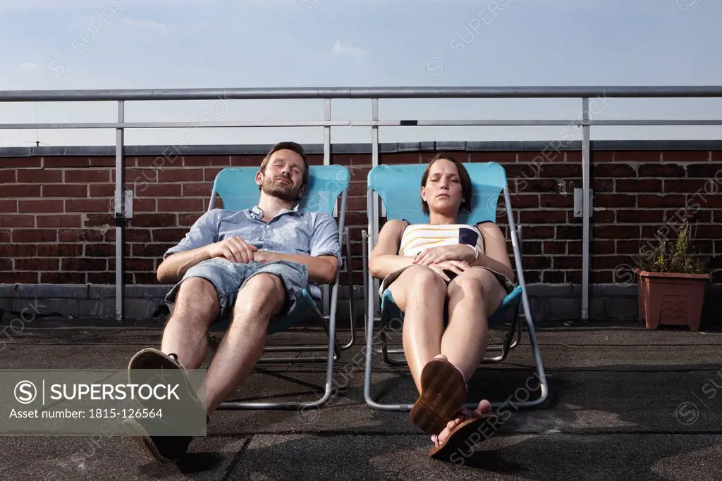 Germany, Berlin, Couple relaxing on roof terrace