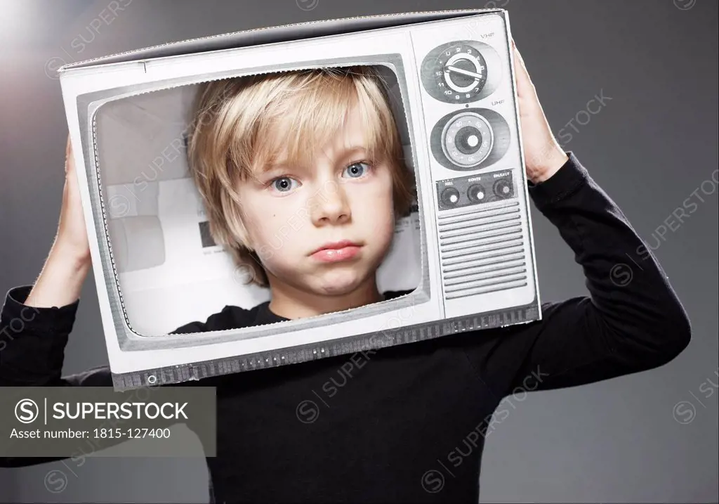Portrait of sad boy head in paper TV against grey background