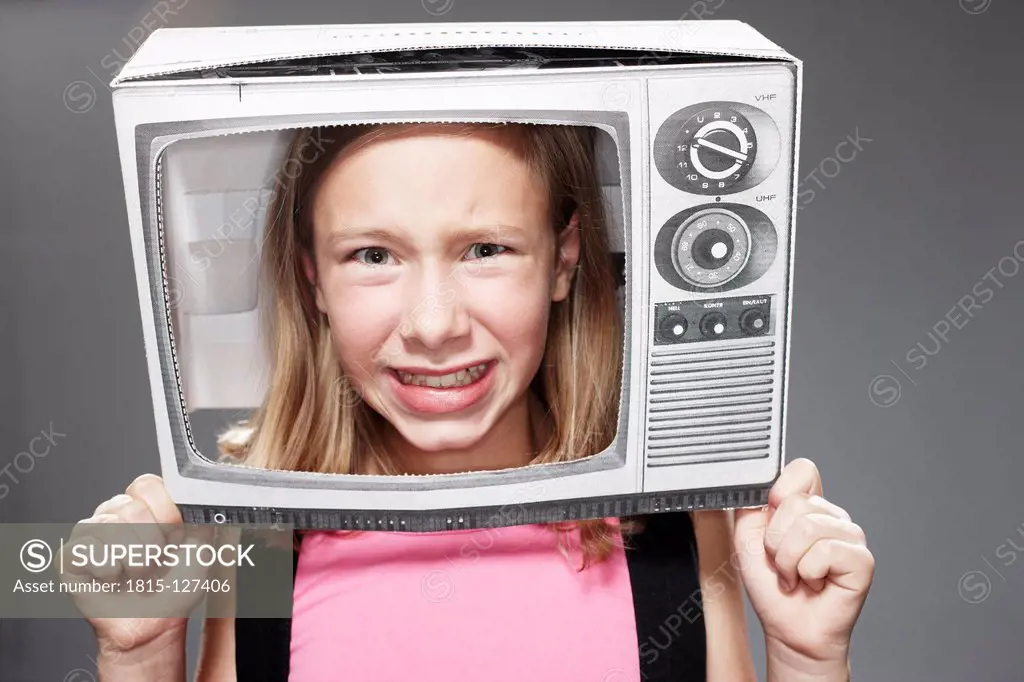 Girl anxious in paper TV against grey background