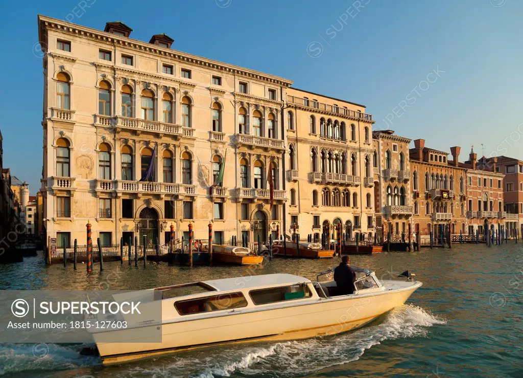Italy, Venice, Man in water taxi on Canal Grande