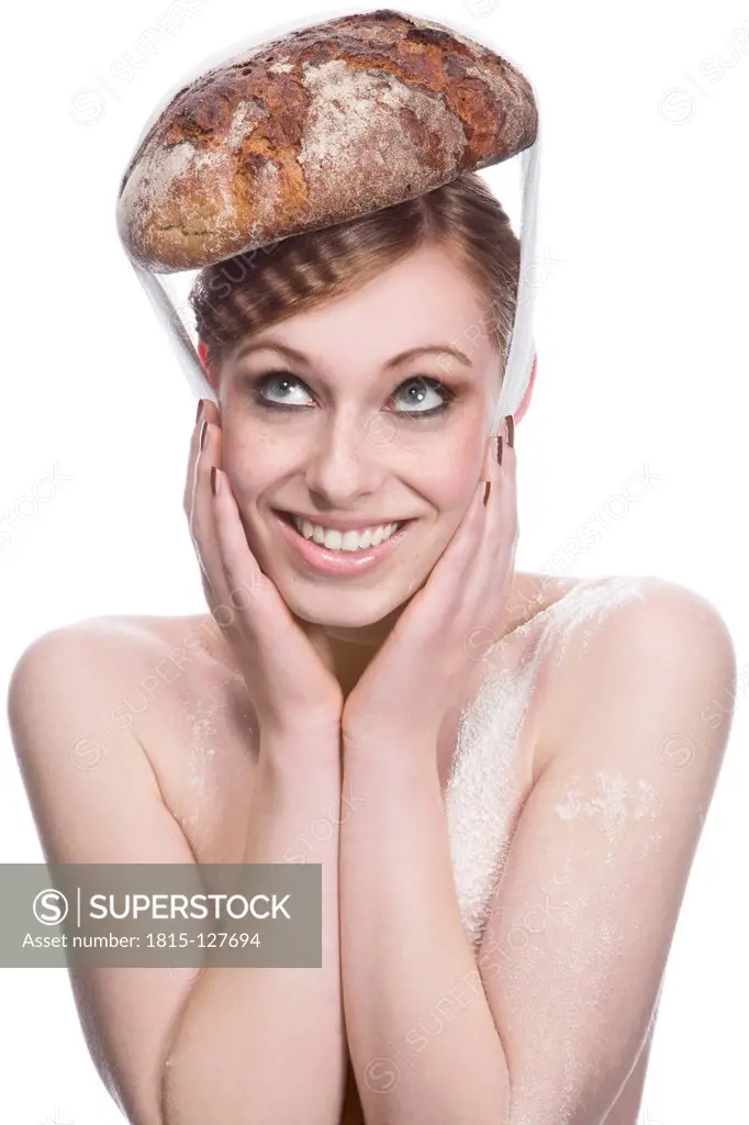 Young woman with bread hat against white background, close up
