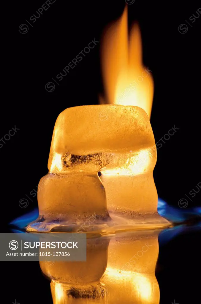 Ice cube burning on black background