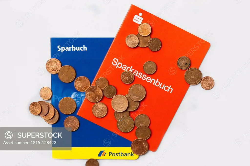 Savings bank book with euro coins on white background, close up