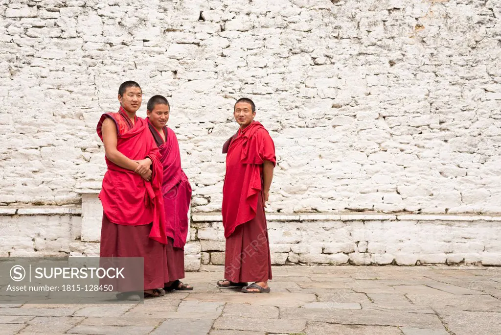 Bhutan, Three monks in Trongsa dzong courtyard
