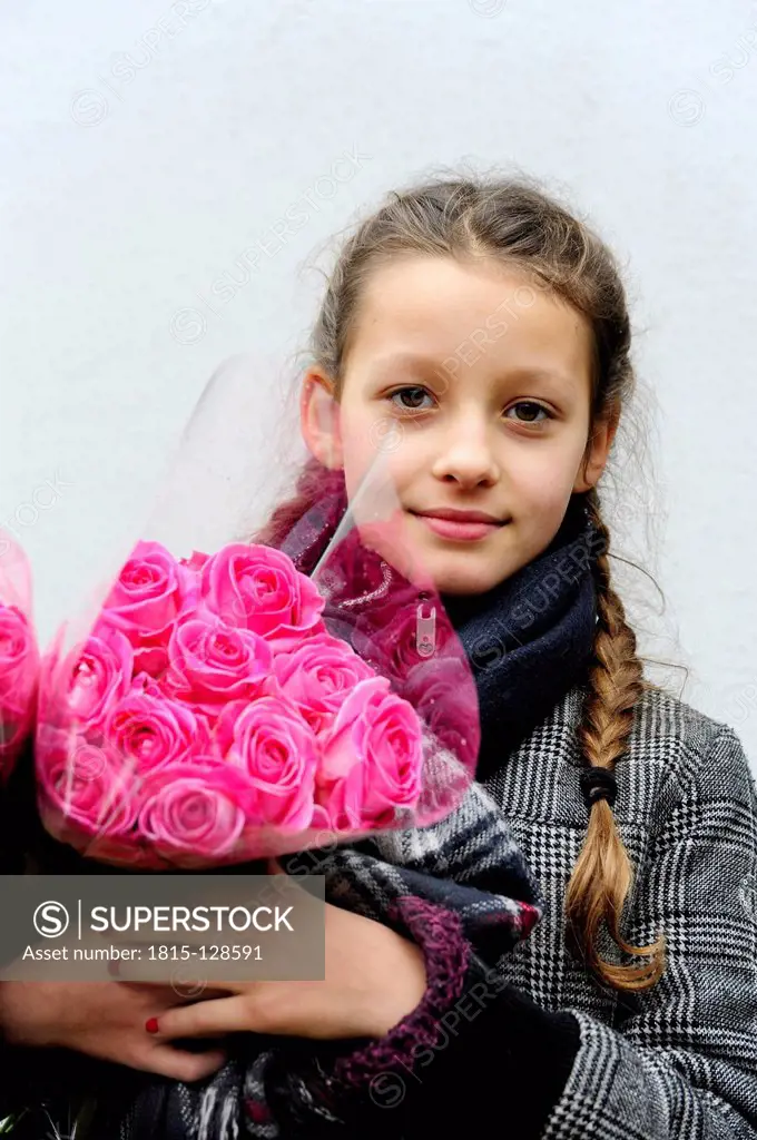 Netherland, Gouda, Girl holding bunch of flowers, close up