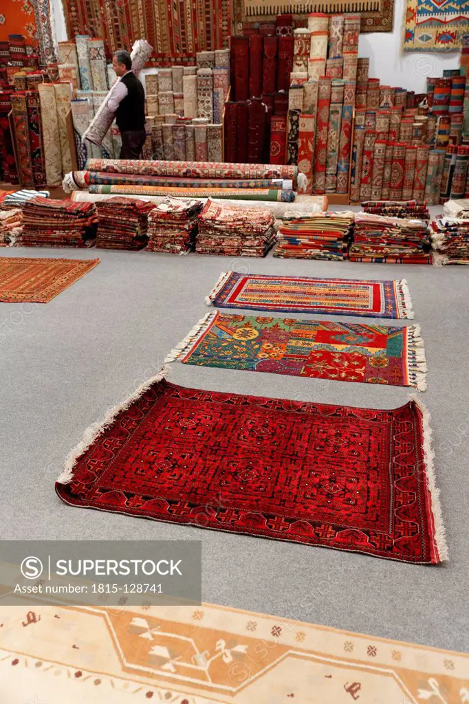 Turkey, Man holding Desen Halicilik Carpet