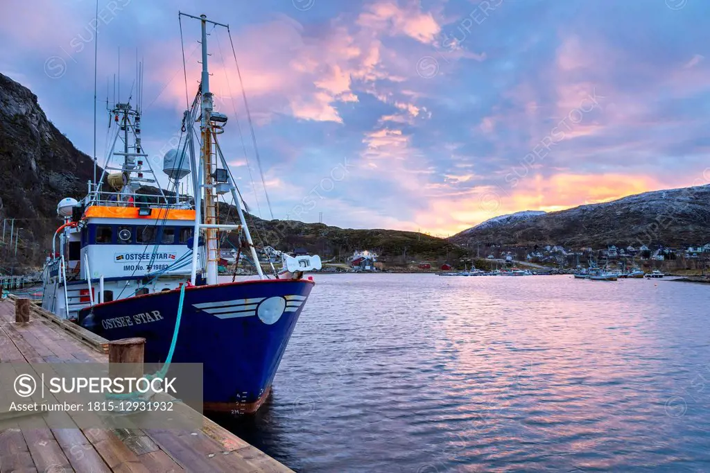 Norway, Troms, Ersfjordbotn, fishing boat in harbour at sunset