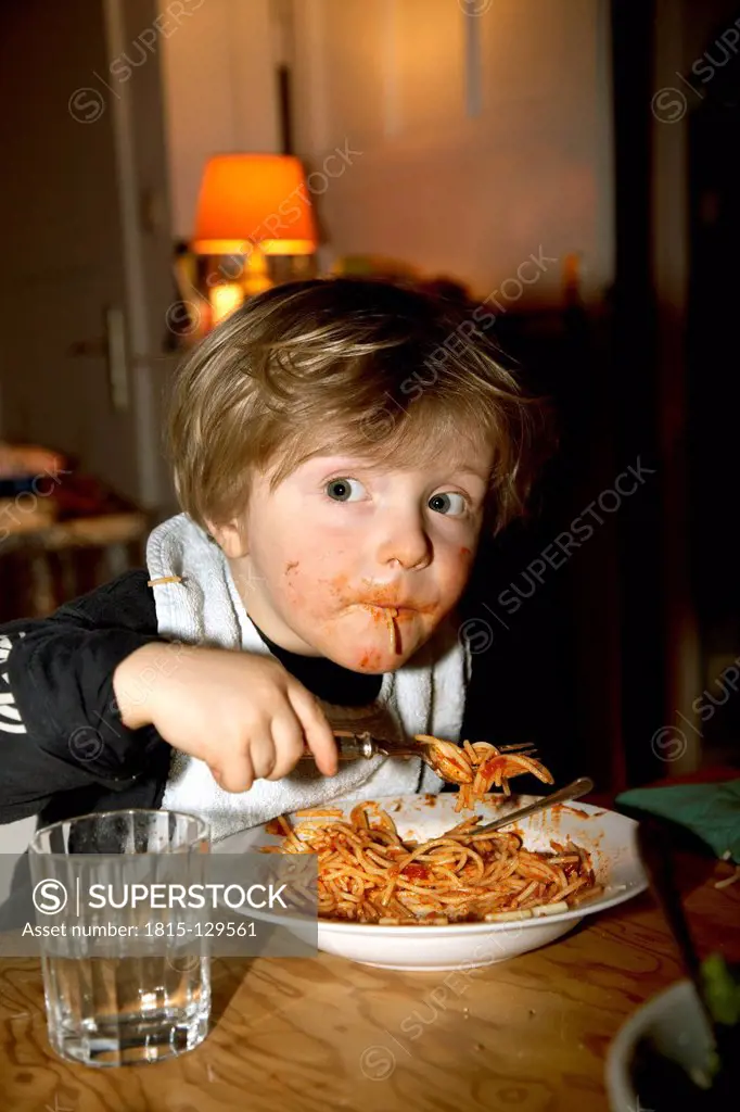 Germany, Boy eating spaghetti, close up