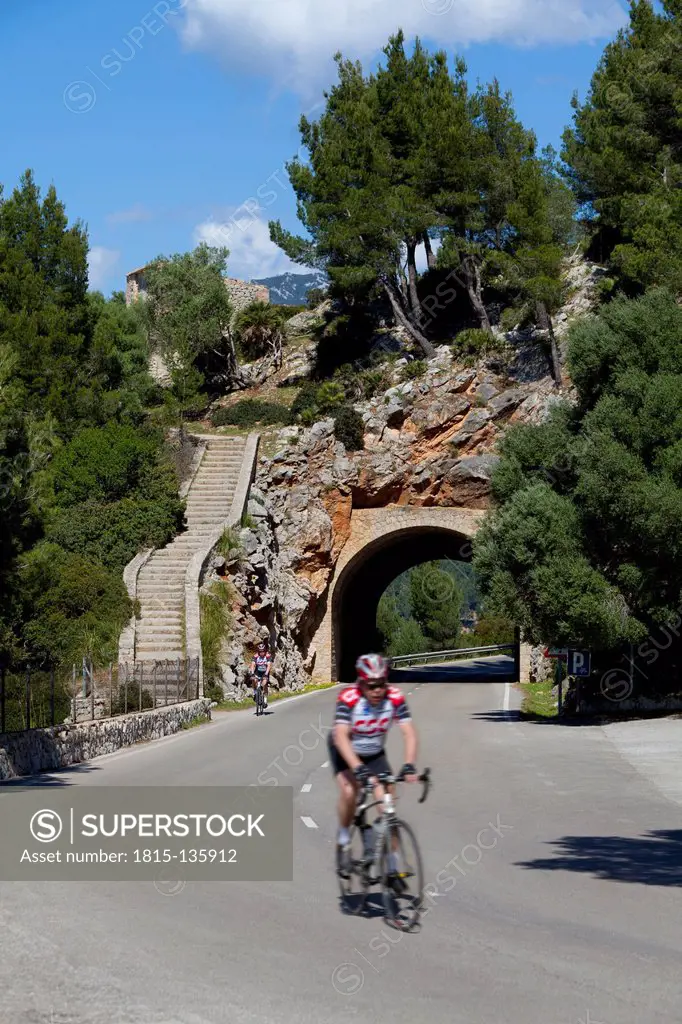 Spain, Mallorca, Man cycling bicycle on mountain road