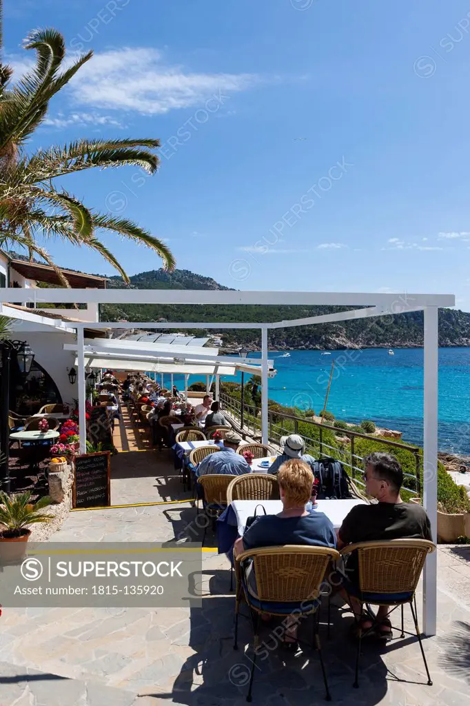 Spain, Balearic Islands, Mallorca, View of restaurants with tourists in Sant Elm