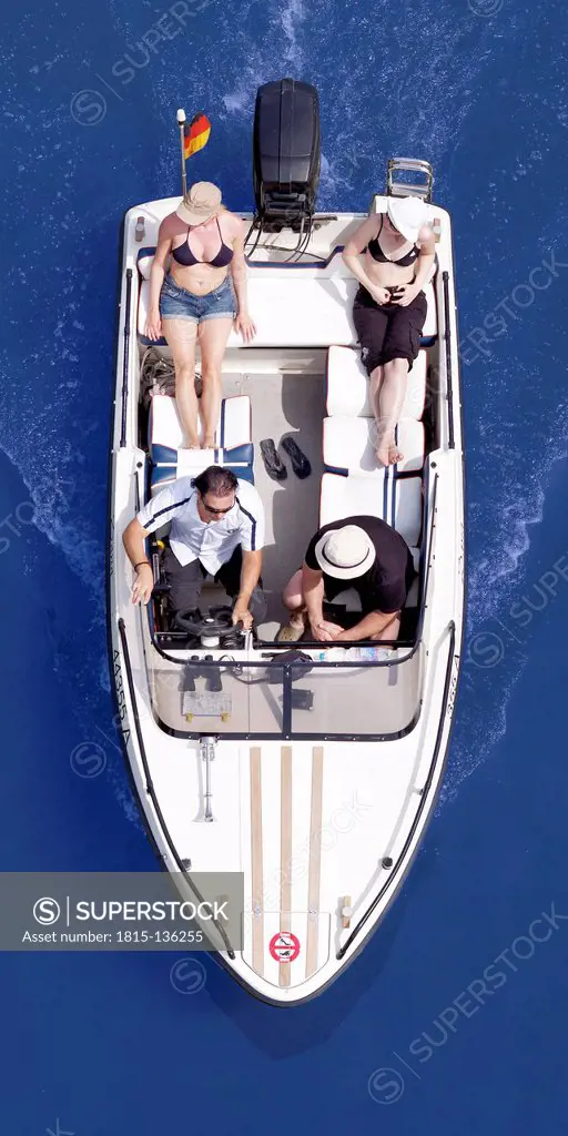 Germany, Men and women excursion with motorboat