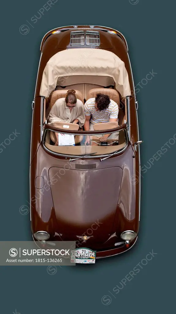 Germany, Hesse, Man and woman sitting in Porsche 356