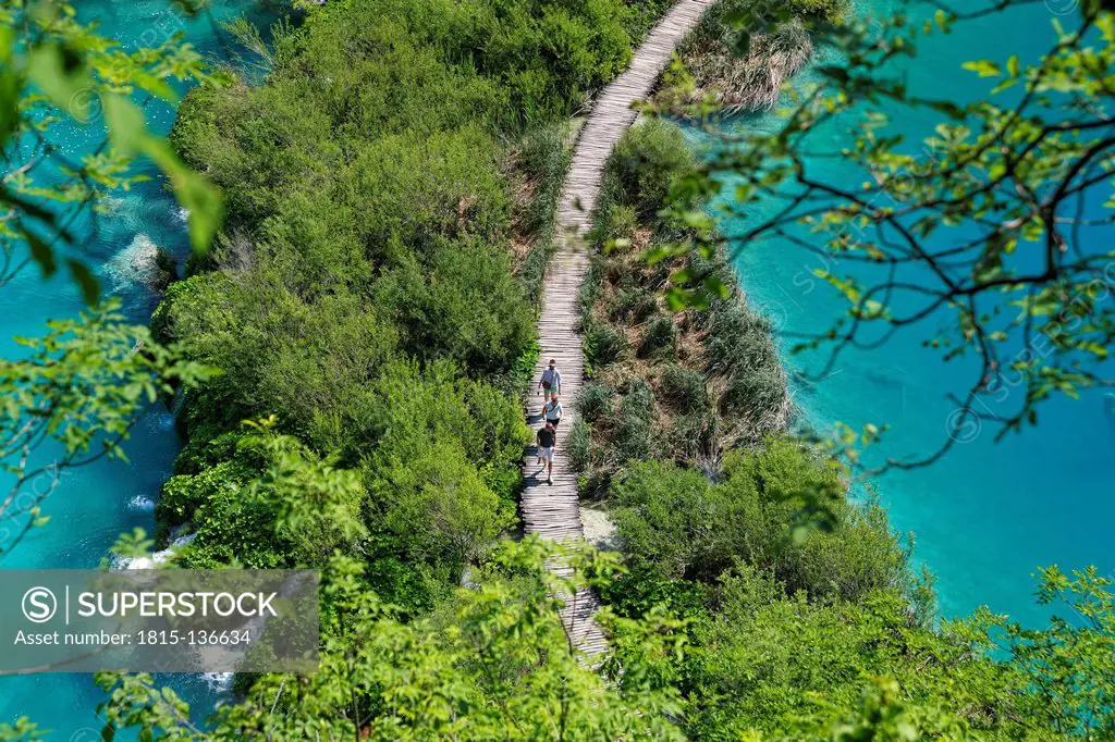 Croatia, Karlovac, Tourist walking on wooden footbridge