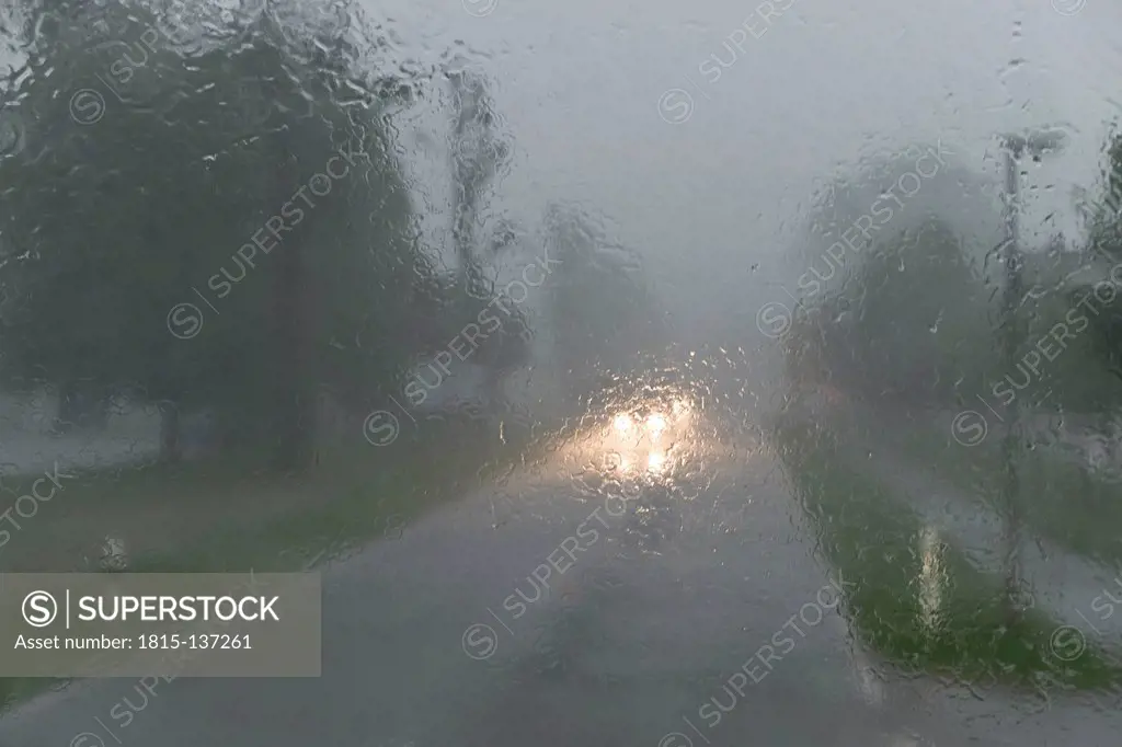 Germany, Rain fall on front windshield of car