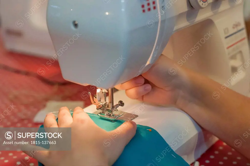 Germany, Saxony, Person working on sewing machine