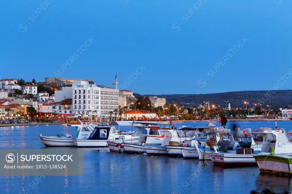 Turkey, Cesme, View of fishing harbour, Cesme castle in background