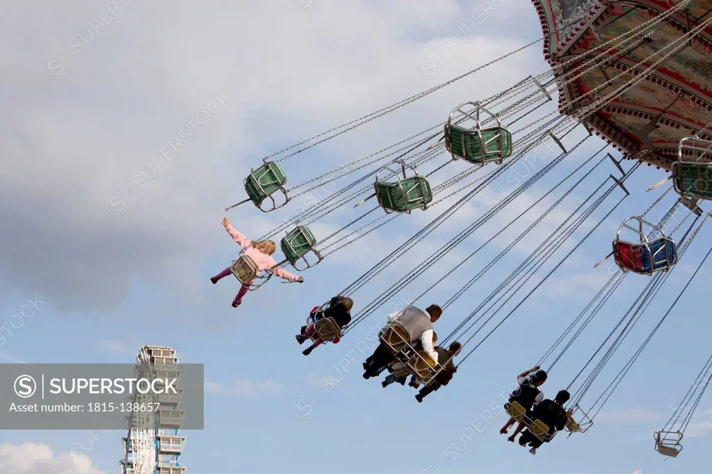 Germany, Bavaria, Munich, People enjoying ride on carousel during Oktoberfest