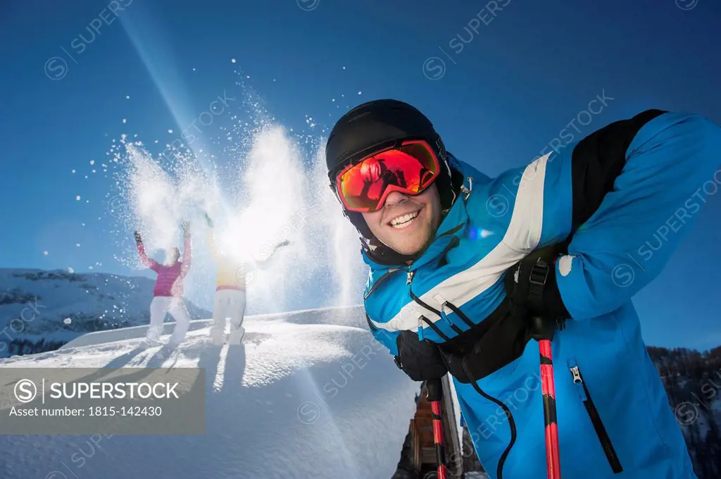 Austria, Salzburg, Young man and women having fun in snow