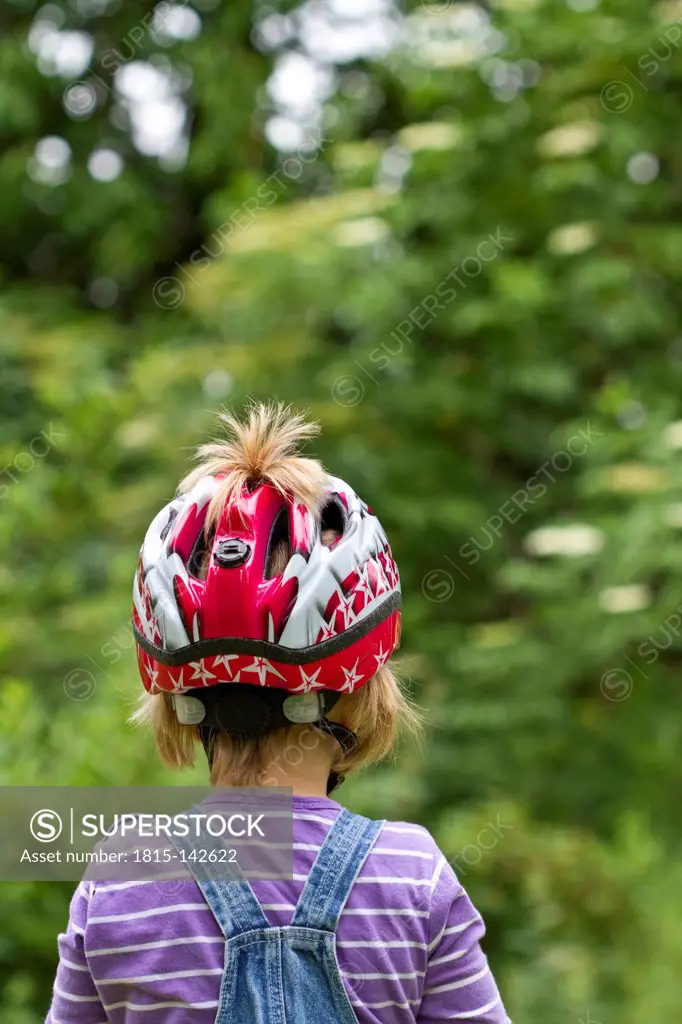 Germany, Kiel, Girl wearing bicycle helmet, close up