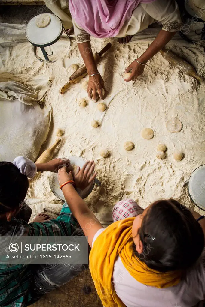 India, Amritsar, Volunters preparing roti bread in Golden temple