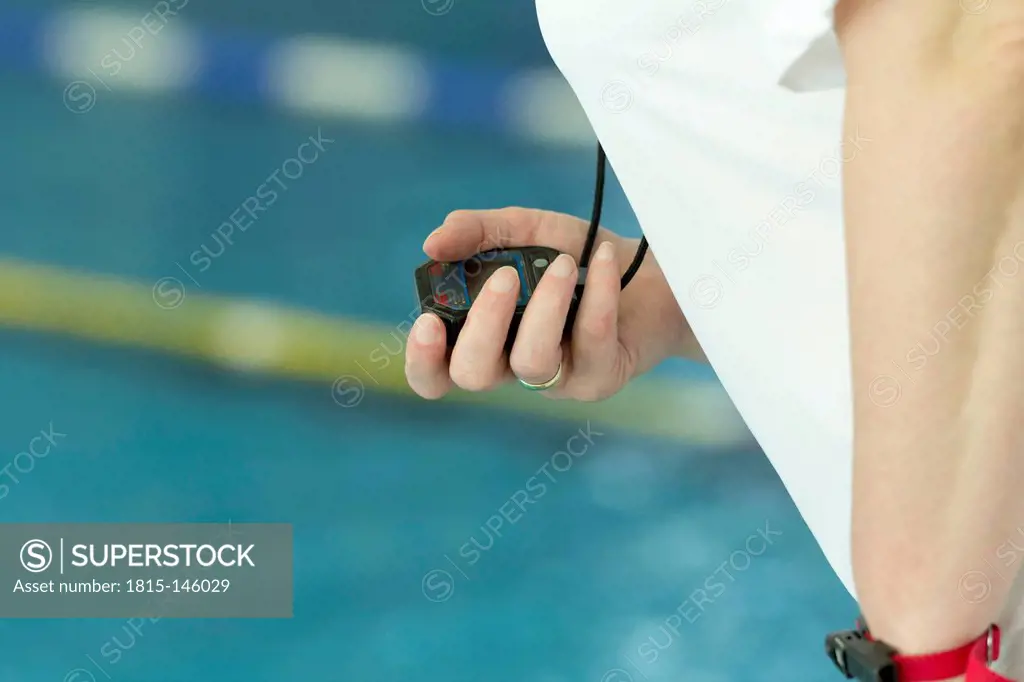 Germany, Baden-Wuerttemberg, Freiburg, swimming competition, referee with stop watch