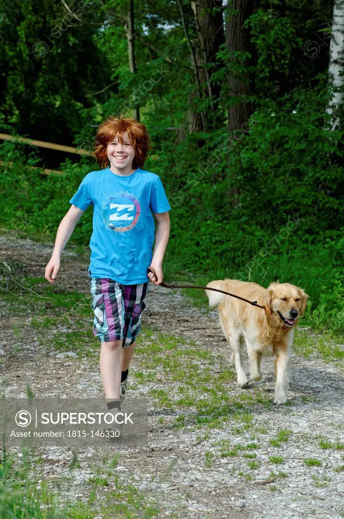 Germany, Bavaria, Boy walking with dog