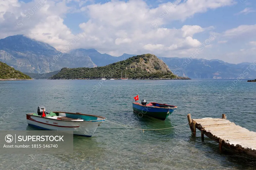 Turkey, Mugla, Fethiye, Boats in Gemiler bay with Gemiler Island in background