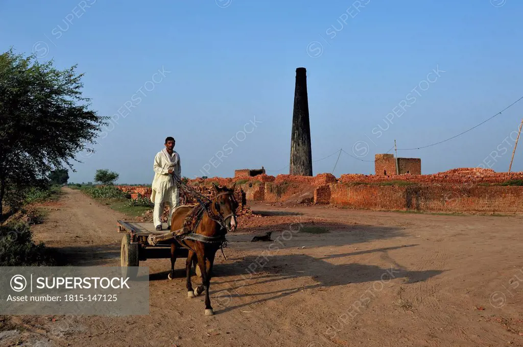 Pakistan, Lahore, Youhanabad II, Man on horse cart in clay factory