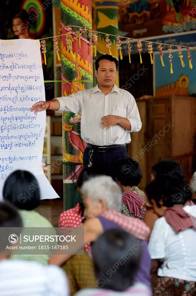 Cambodia, Takeo Province, Members of aid organisation discussing improvements of water supply with villagers