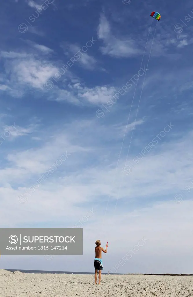 Germany, Lower Saxony, East Frisia, Langeoog, boy flying a kite
