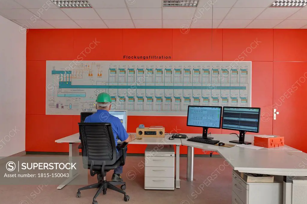 Germany, Baden-Wurttenberg, Man working in control center of water treatment plant