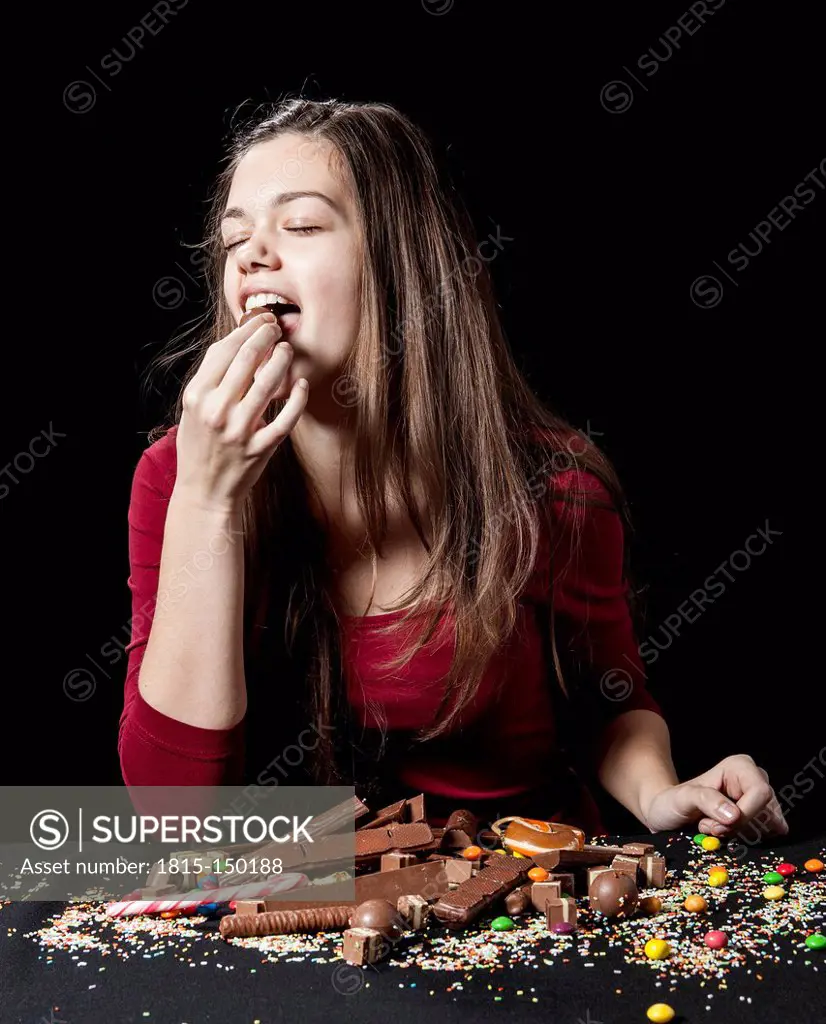 Teenage girl eating a chocolate ball